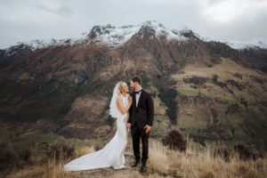 bride and groom pose for wedding photos at Beyonet Peak in Queenstown New Zealand