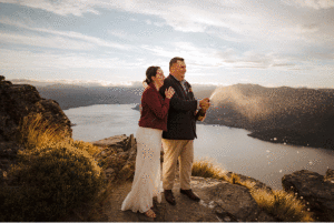 bride and groom pop and spray champagne at Cecil Peak in Queenstown New Zealand