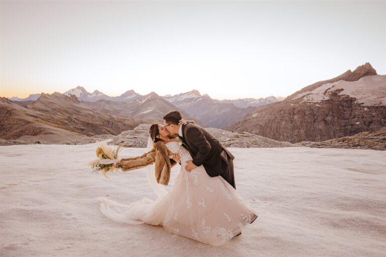 bride and groom dance and kiss at Tyndall Glacier in the snow, Queenstown, New Zealand