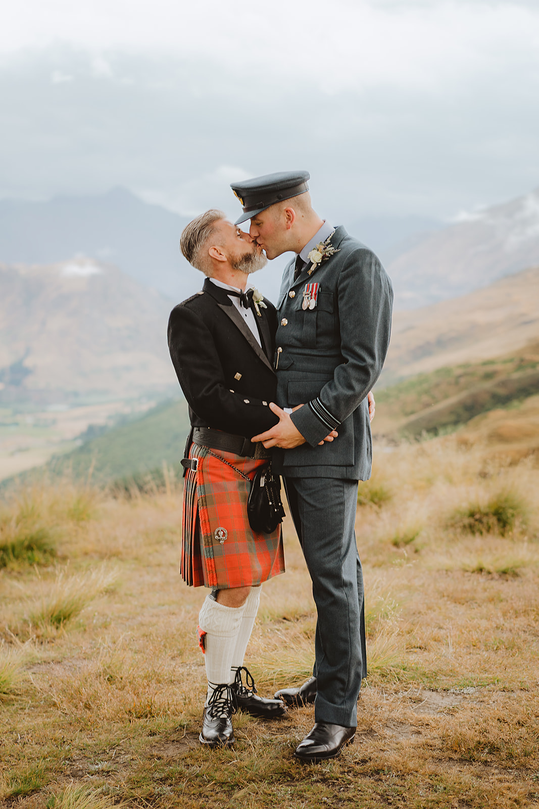 Two grooms kiss at Coronet Peak after their wedding ceremony