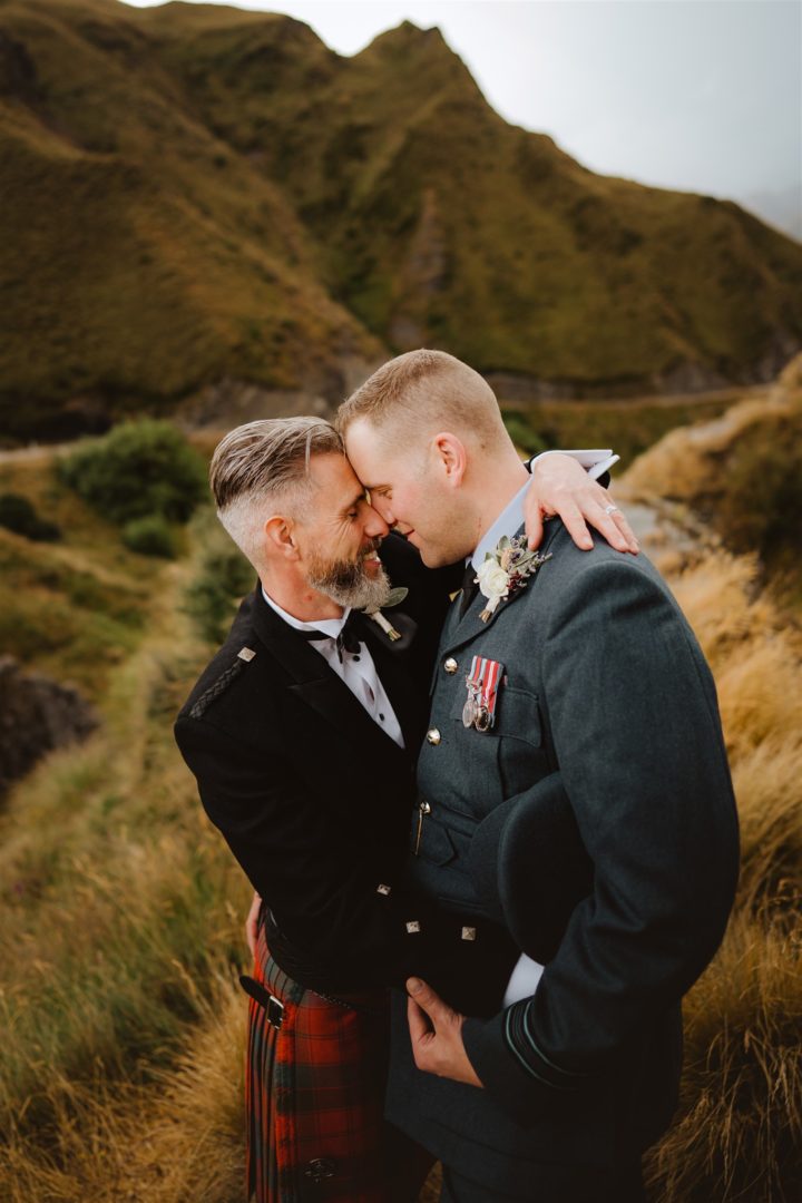 Two grooms cuddling close at Skippers Canyon Queenstown
