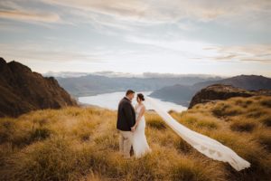 bride and groom pose for photos at Cecil Peak in Queenstown New Zealand