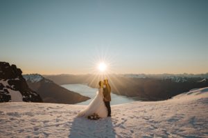 Bride and groom share first kiss after wedding ceremony in the snow at The Remarkables in Queenstown