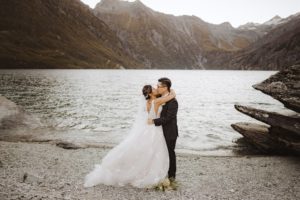 Bride and groom first kiss beside Lochnagar, Queenstown, New Zealand