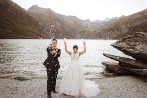 bride and groom spraying champagne at Lochnagar in Queenstown New Zealand