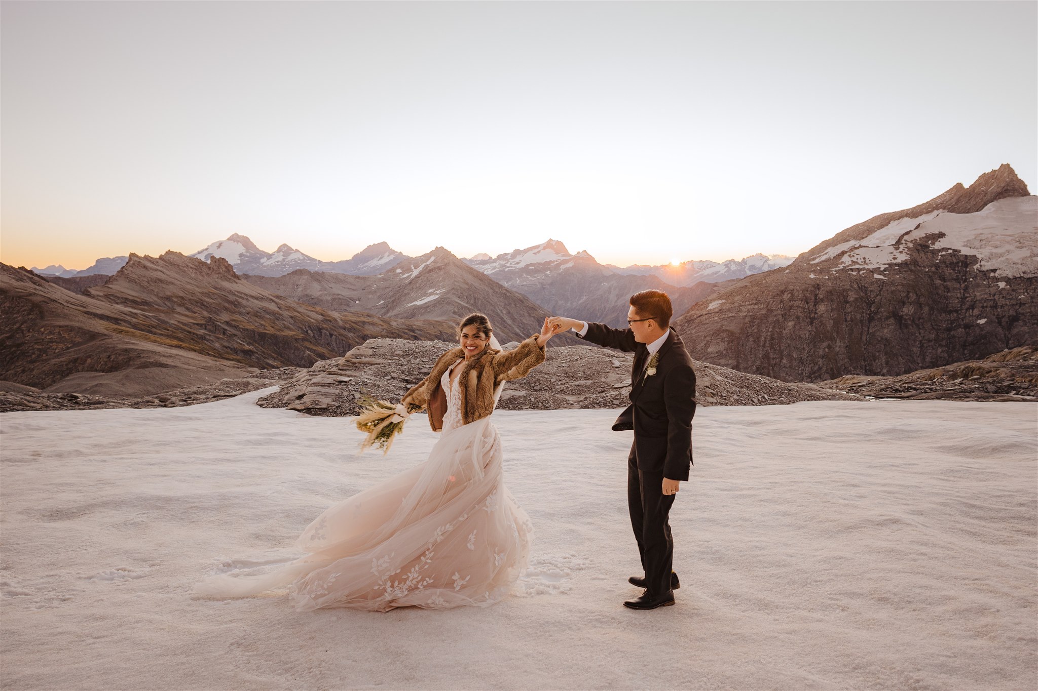 bride and groom dancing on glacier in Queenstown New Zealand