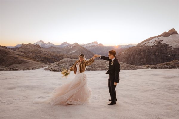 bride and groom dancing in the snow on a glacier for their Queenstown wedding in New Zealand