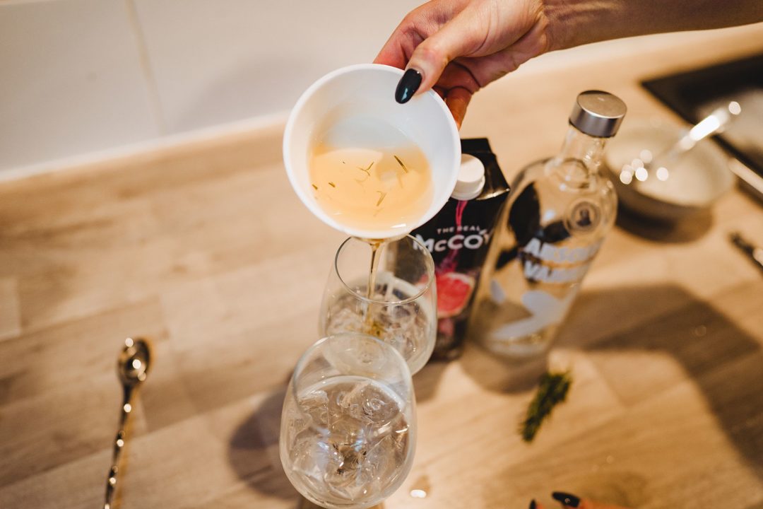 adding rosemary infused simple syrup to vodka cocktail