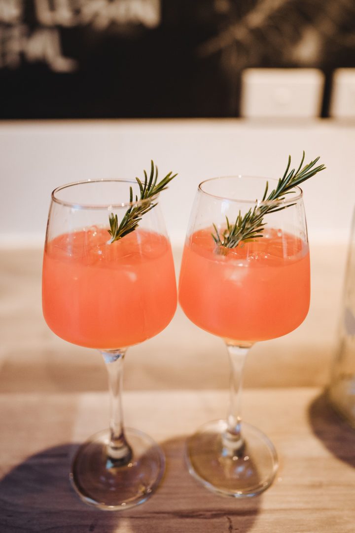 Vodka grapefruit juice and rosemary infused cocktail with fresh rosemary garnish