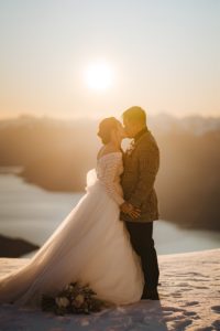 bride and groom kissing at sunset after wedding ceremony at The Remarkables, Queenstown, New Zealand