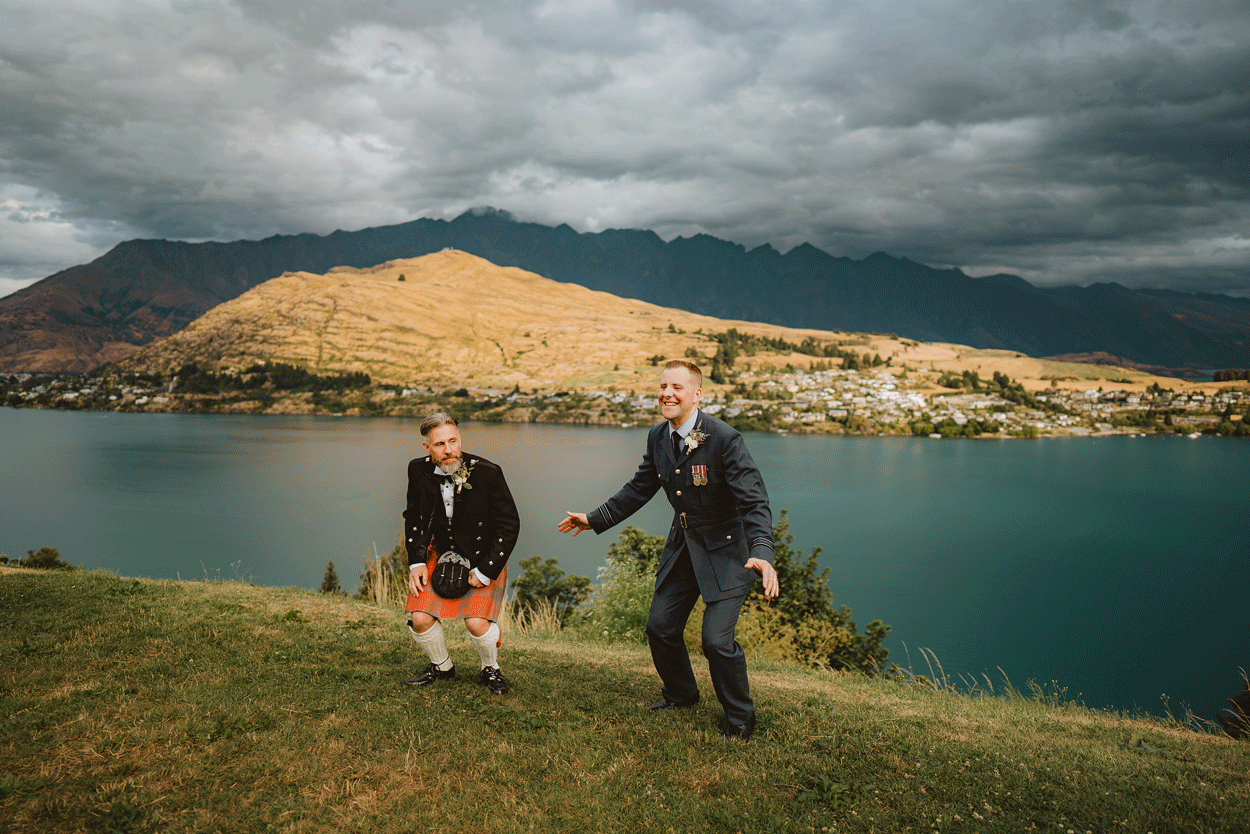 gay wedding Queenstown with two grooms doing star jumps
