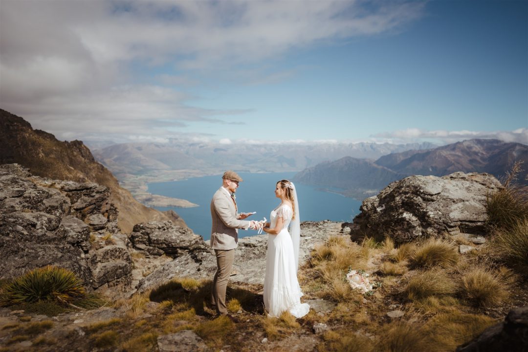 Bride and groom reading their wedding vows on top of a mountain in Queenstown New Zealand