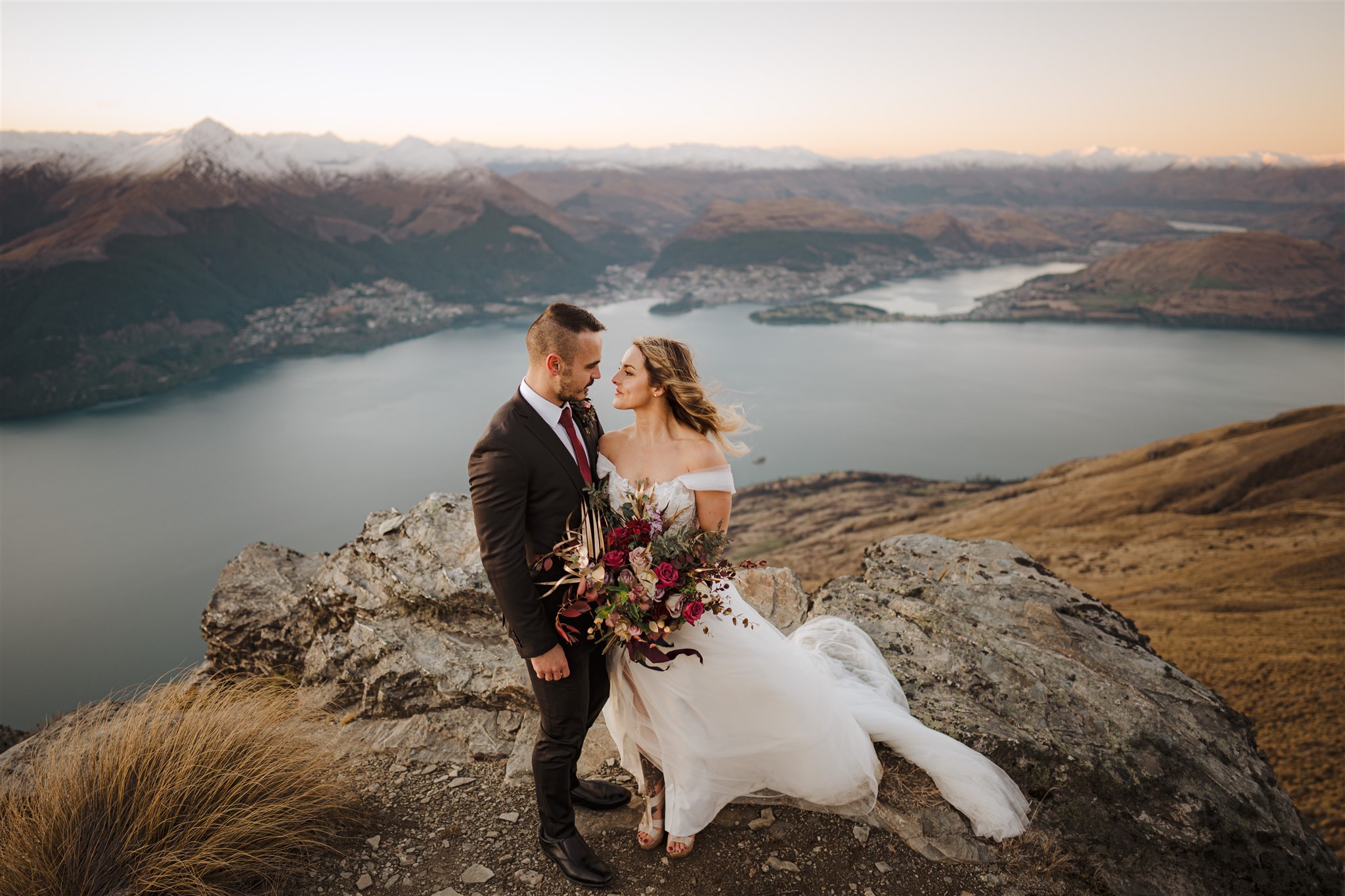 bride and groom at The Ledge, Cecil Peak, Queenstown, New Zealand with Lake Wakatipu