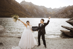 gif video of bride and groom holding elopement sign after their heli-wedding at Locjnagar