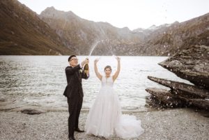 Groom sprays champagne from the bottle after heli-wedding at Lochnagar