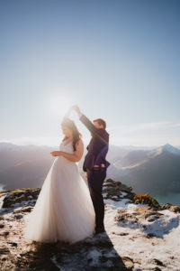 newlyweds first dance in the snow as husband and wife at winter wedding in queenstown new zealand