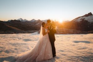 bride and groom kiss at sunset on Tyndall Glacier in Queenstown New Zealand